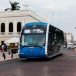 modern bus on city street near colonial architecture