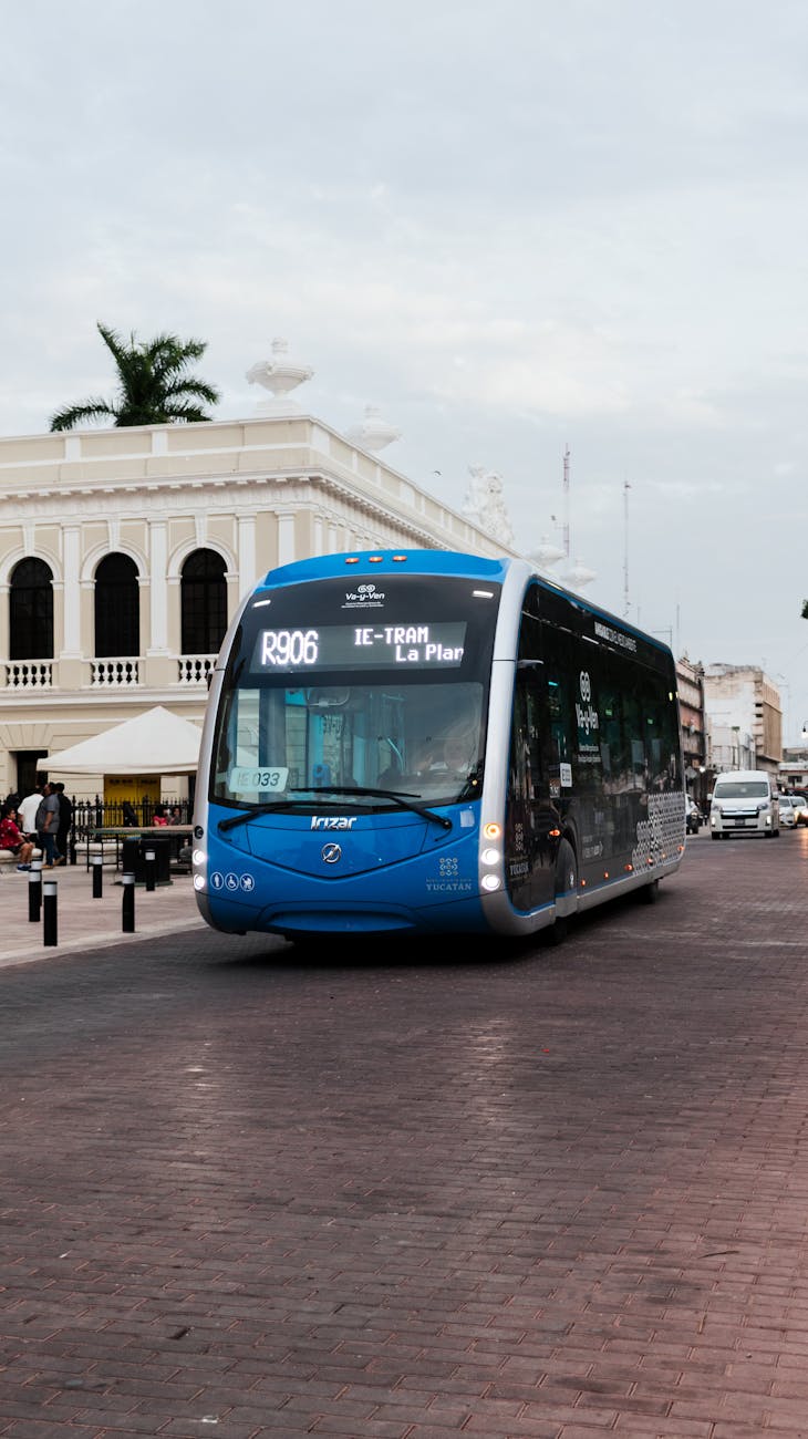 modern bus on city street near colonial architecture